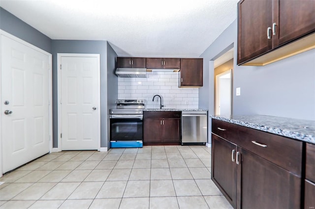 kitchen featuring light stone counters, sink, dark brown cabinets, and appliances with stainless steel finishes