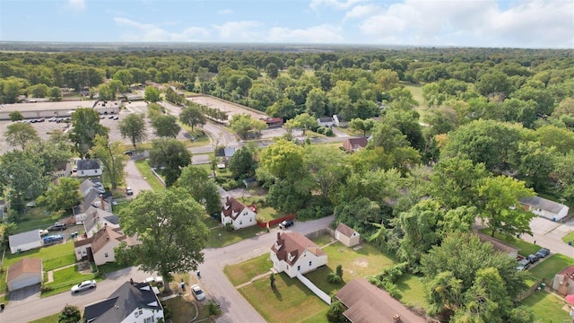 drone / aerial view with a forest view and a residential view