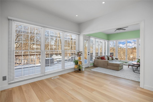 sunroom / solarium featuring ceiling fan and a healthy amount of sunlight