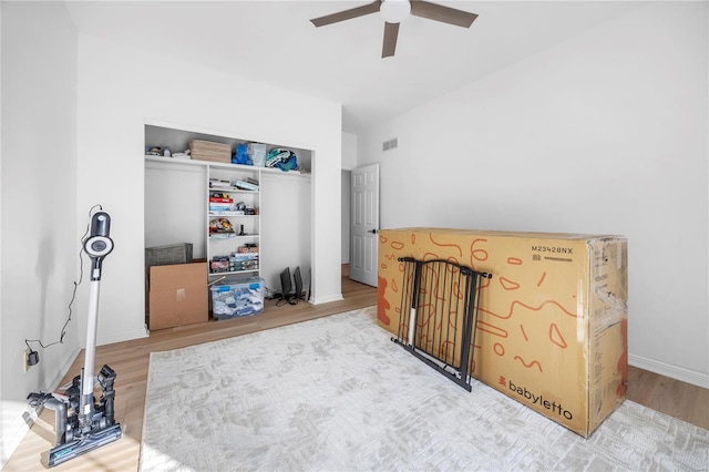 bedroom featuring ceiling fan, a closet, and hardwood / wood-style flooring