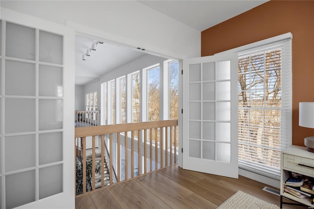 interior space with rail lighting and light wood-type flooring