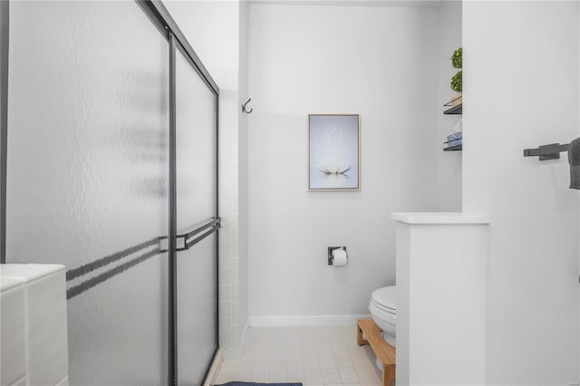 bathroom with a shower with shower door and toilet