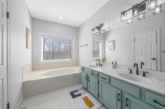 bathroom featuring vanity, tile patterned flooring, and tiled bath