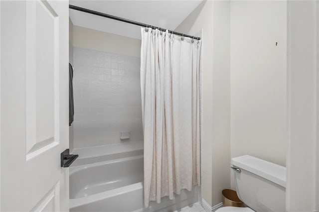 bathroom featuring shower / bath combination with curtain and toilet