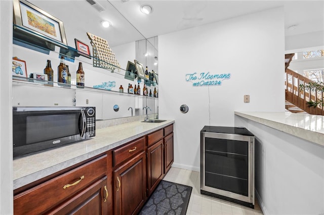 bar with sink and beverage cooler