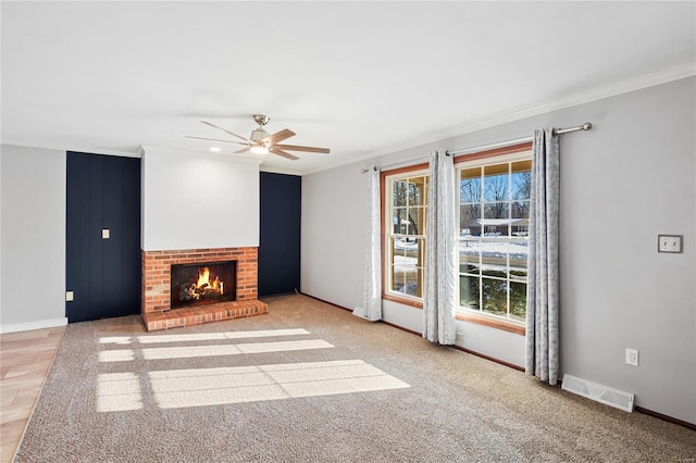 unfurnished living room featuring a brick fireplace, ceiling fan, light carpet, and ornamental molding