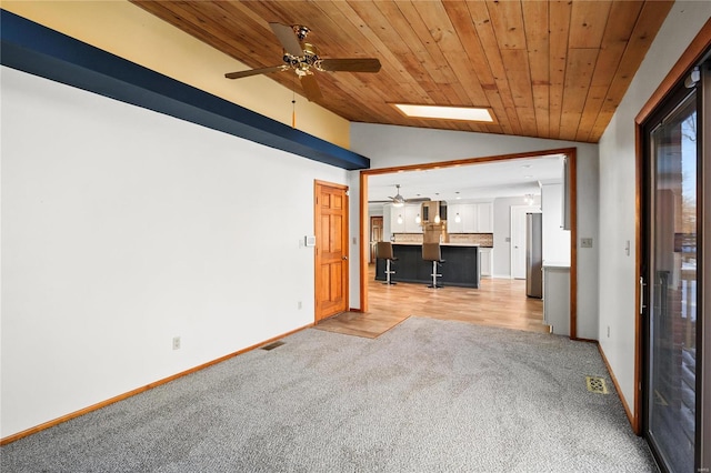 unfurnished living room featuring lofted ceiling, light carpet, ceiling fan, and wood ceiling