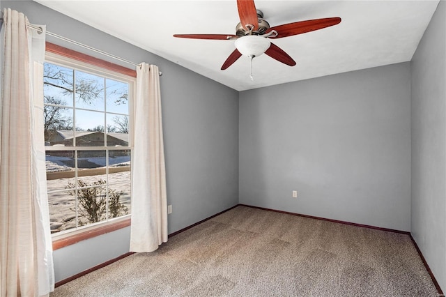 spare room with ceiling fan and light colored carpet