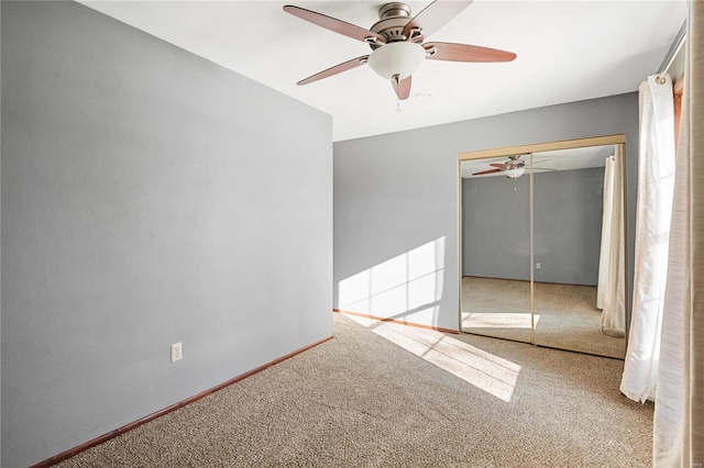 unfurnished bedroom with a closet, ceiling fan, and carpet