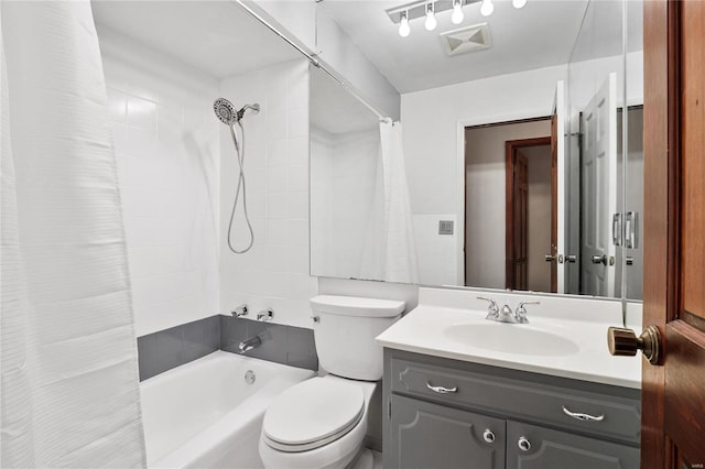 full bathroom featuring shower / bathtub combination with curtain, vanity, and toilet