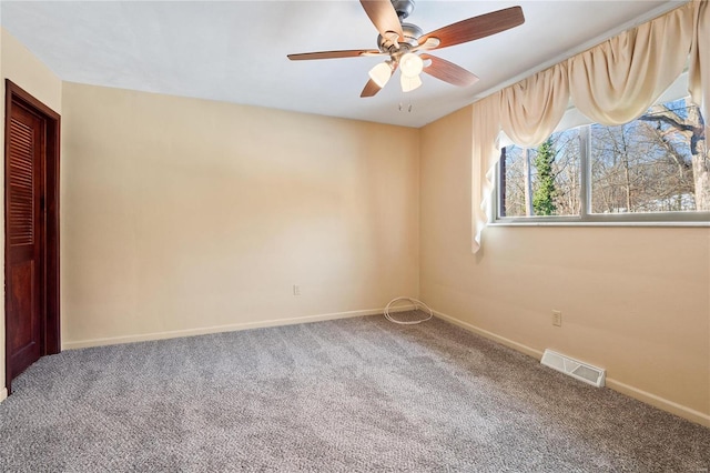 spare room featuring ceiling fan and carpet floors