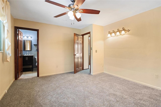 carpeted spare room featuring ceiling fan