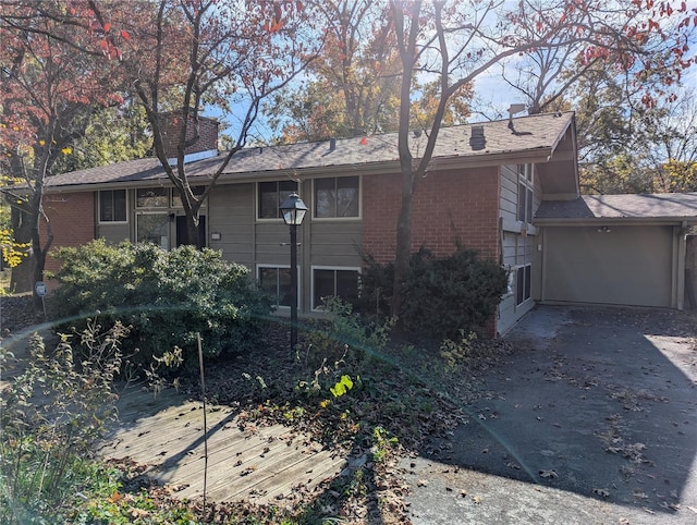 rear view of property featuring a garage