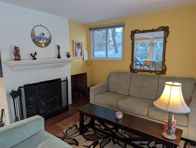 living room with a fireplace and dark tile patterned flooring