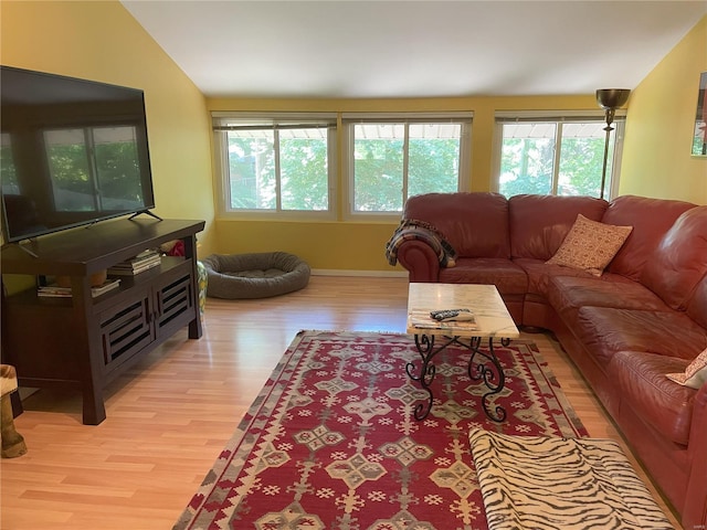 living room featuring vaulted ceiling and light wood-type flooring