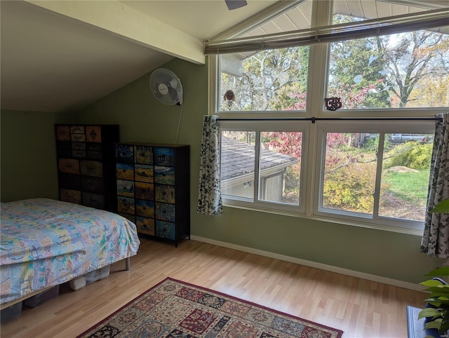 bedroom with wood-type flooring, vaulted ceiling with beams, and ceiling fan