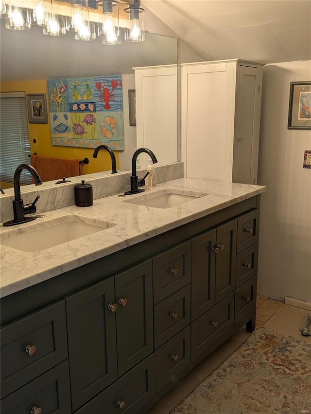 bathroom featuring tile patterned flooring, vanity, and lofted ceiling