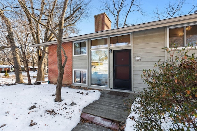 view of snow covered property entrance