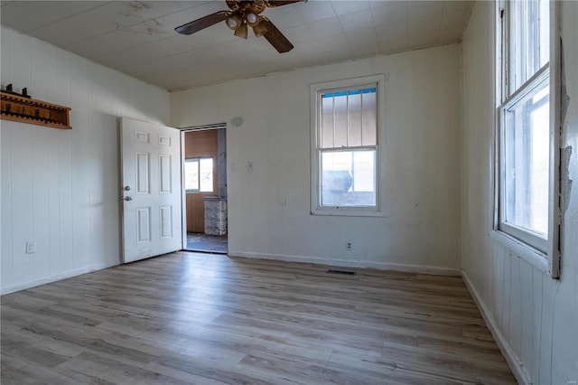 spare room featuring ceiling fan and light hardwood / wood-style flooring