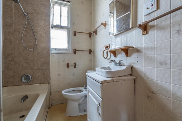 full bathroom with tile walls, toilet, vanity, and bathing tub / shower combination