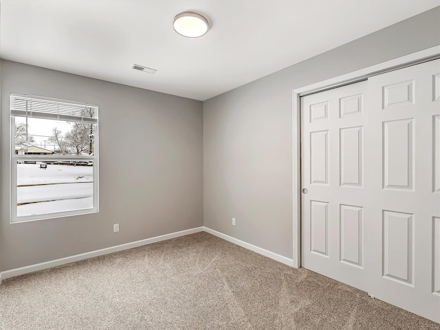 unfurnished bedroom with carpet flooring and a closet