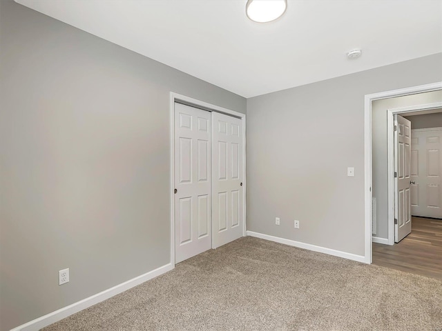 unfurnished bedroom with carpet floors and a closet