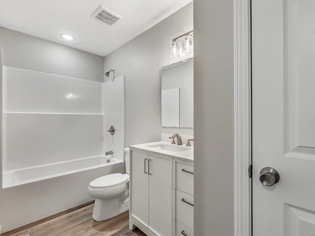 full bathroom featuring vanity,  shower combination, hardwood / wood-style flooring, and toilet