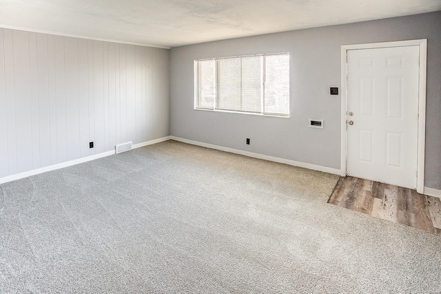 spare room featuring wooden walls