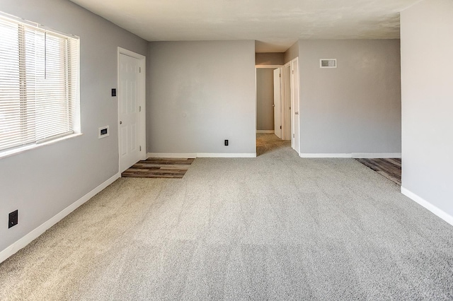 empty room with light colored carpet