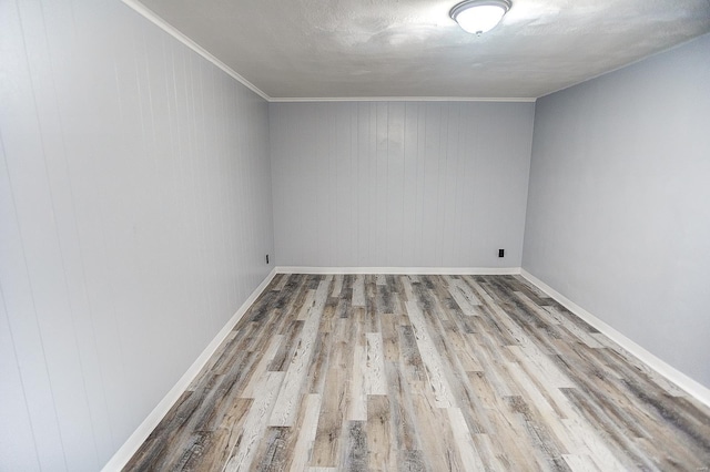 spare room with hardwood / wood-style floors and wood walls