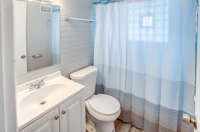 bathroom with a shower with curtain, vanity, hardwood / wood-style flooring, and toilet