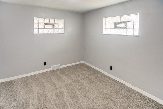 carpeted spare room with a healthy amount of sunlight