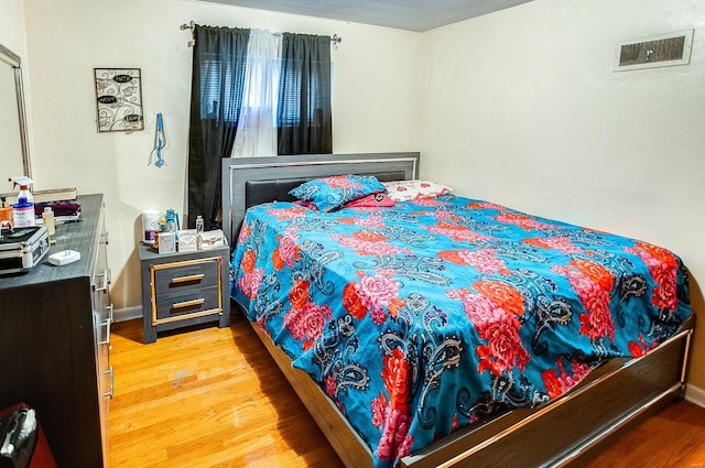 bedroom with hardwood / wood-style flooring