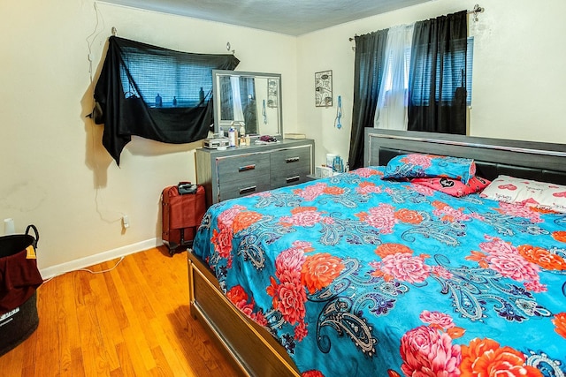 bedroom with wood-type flooring and a textured ceiling