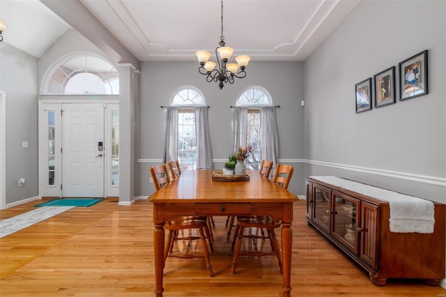 dining space featuring light hardwood / wood-style floors and a notable chandelier