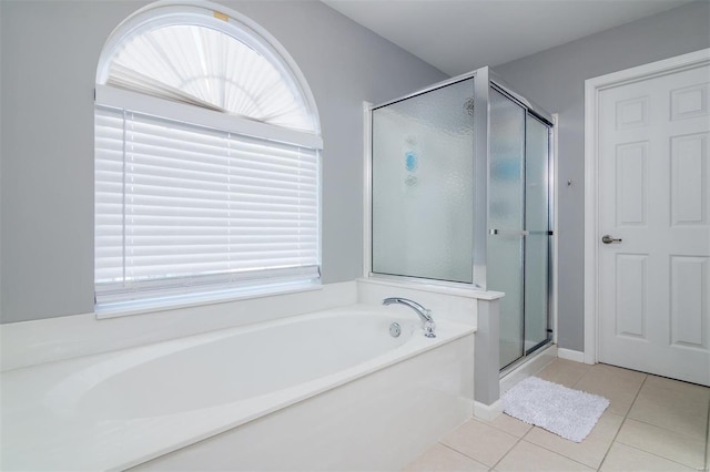 bathroom featuring tile patterned flooring and independent shower and bath