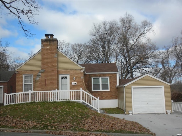 view of front facade featuring a garage and an outdoor structure