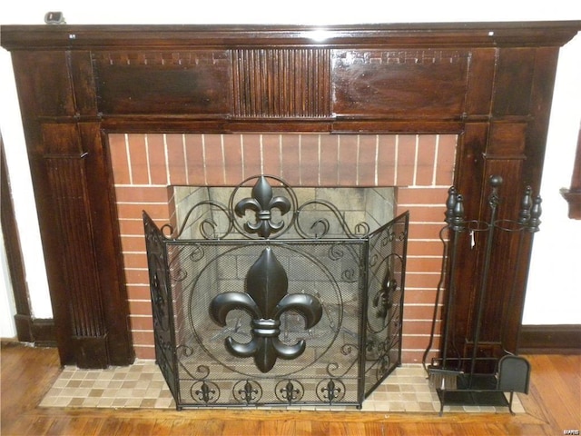 room details featuring a fireplace and hardwood / wood-style flooring