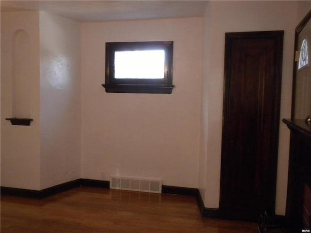 unfurnished room with hardwood / wood-style flooring