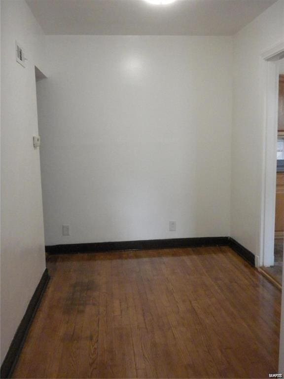 spare room featuring dark hardwood / wood-style floors