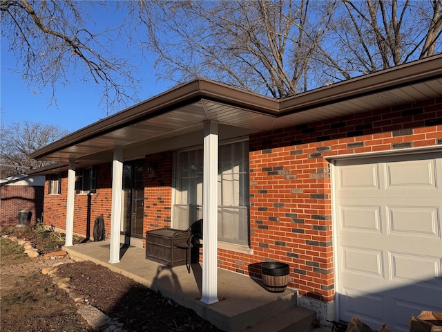 view of side of property with a garage and a porch