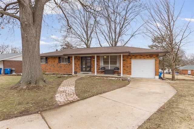 single story home with a porch, a garage, and a front lawn