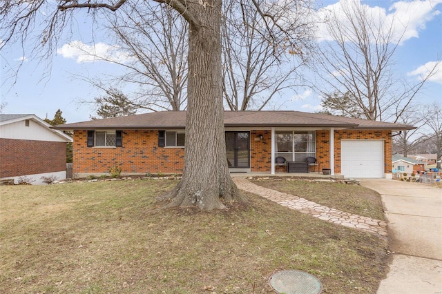 ranch-style home with a garage and a front lawn