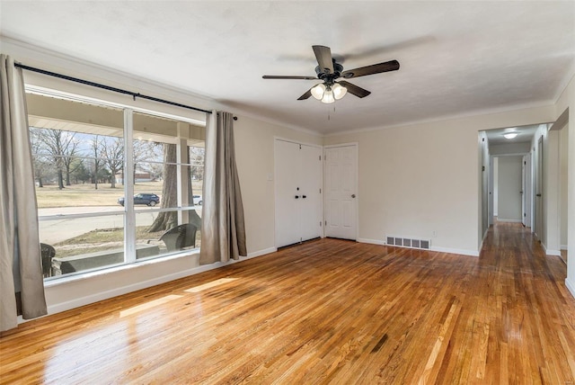 unfurnished room with ceiling fan and light wood-type flooring