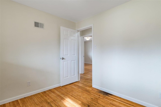 spare room with light hardwood / wood-style floors