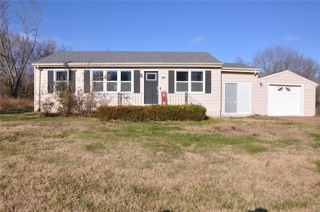 ranch-style house featuring a garage and a front lawn