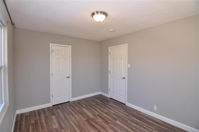 empty room with dark wood-type flooring