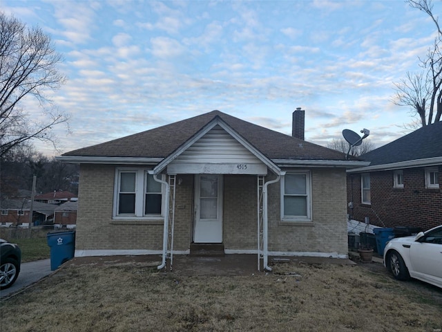 bungalow-style house featuring a front yard