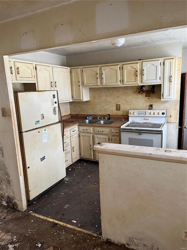 kitchen featuring cream cabinetry, white appliances, and sink