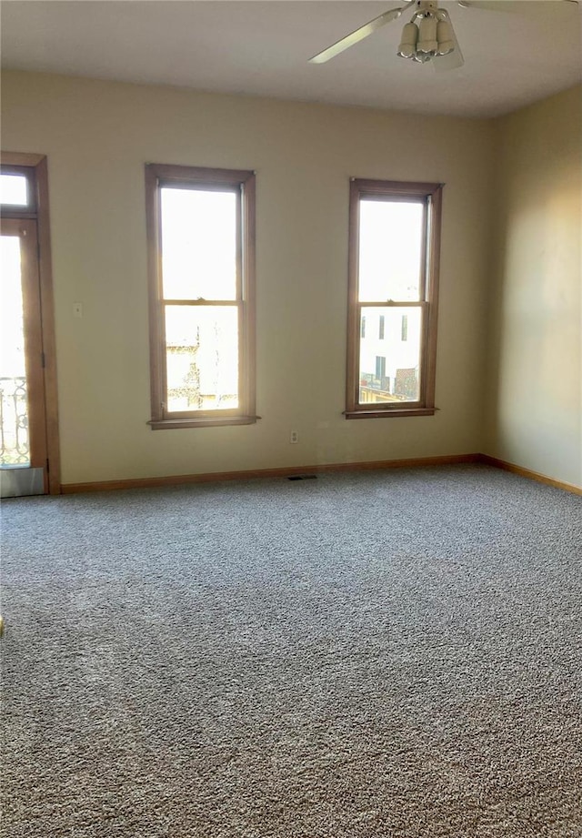 empty room with ceiling fan and carpet floors